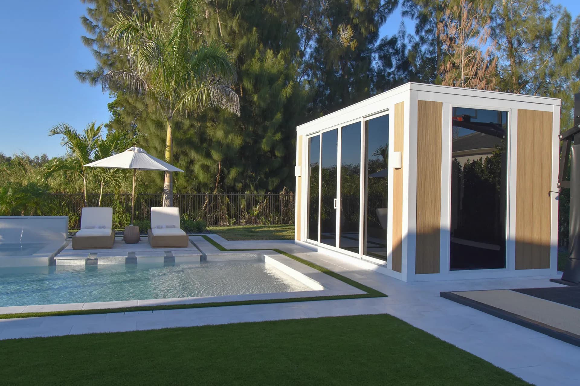Luxapod close-up — white aluminum frame with wood accent panels and sliding glass doors