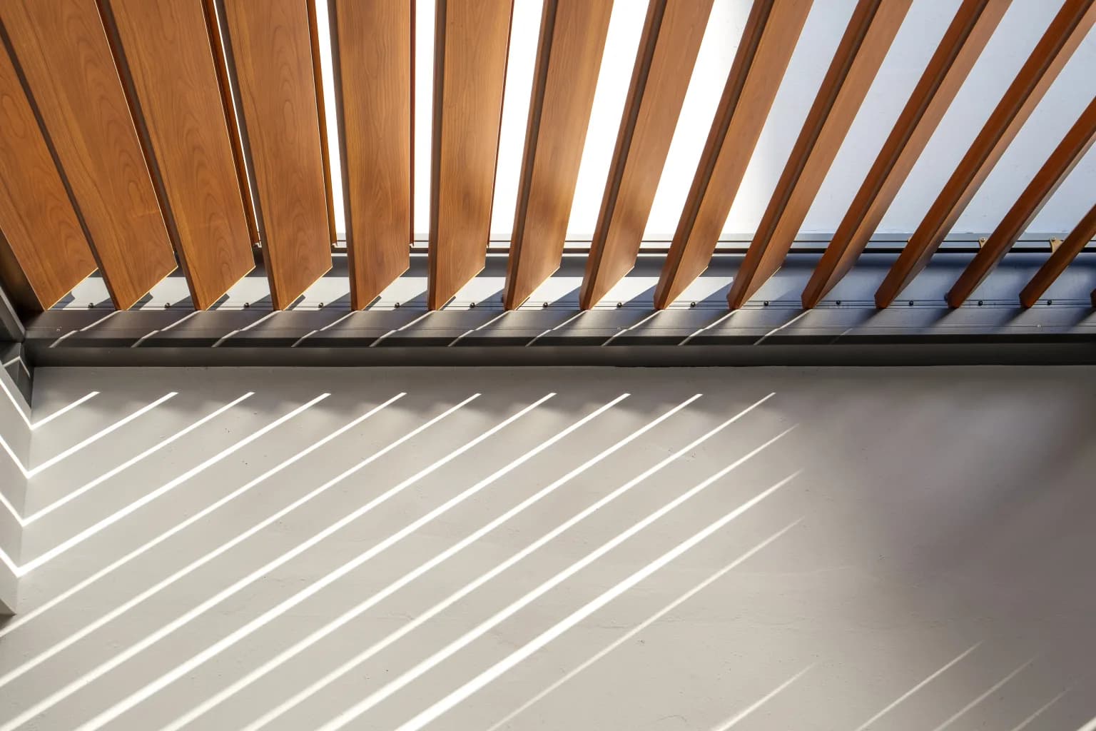 R-BLADE louvers detail with wood-grain ceiling