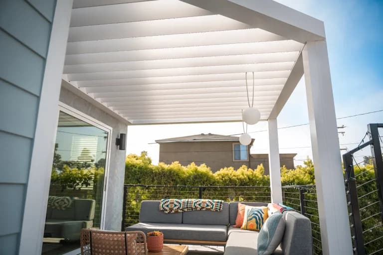 White R-BREEZE covering a residential patio with a modern outdoor couch