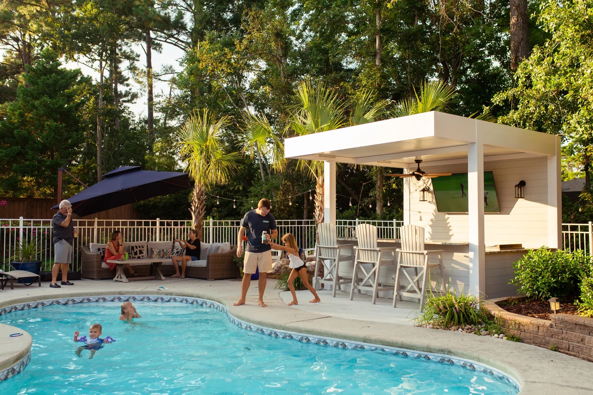 R-SHADE patio cover providing shade for a family lounge