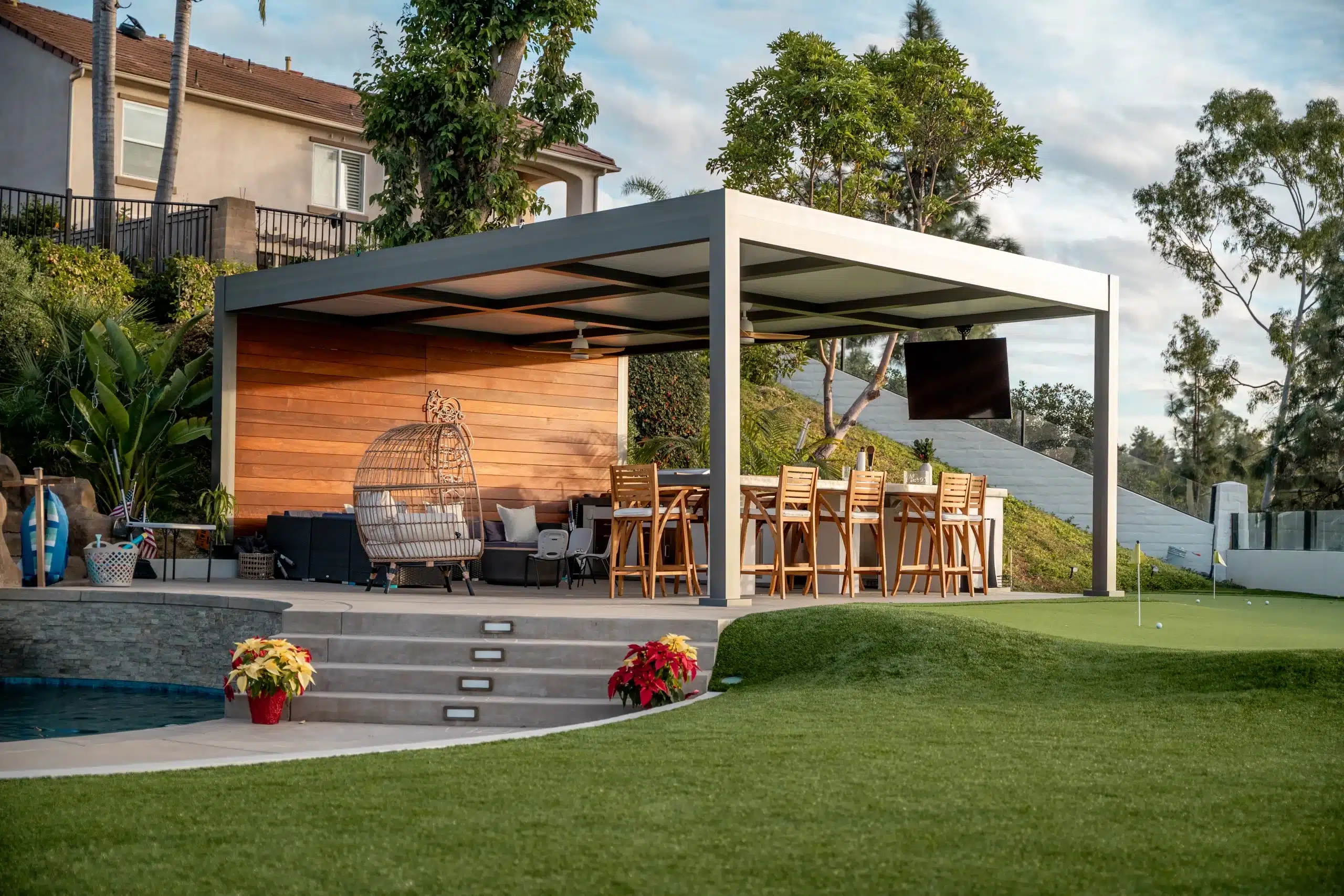 R-SHADE insulated patio cover over an outdoor living room with TV